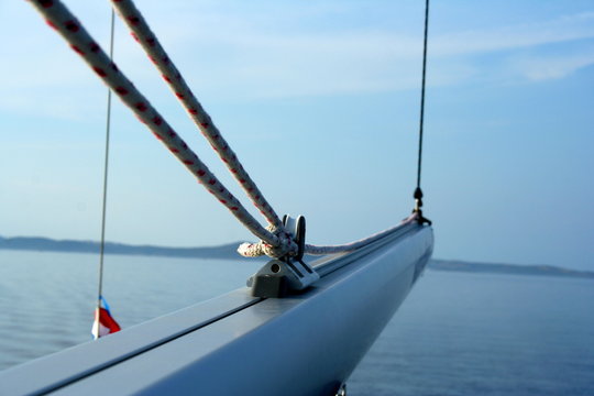 Sailing boom (spar) on the yacht with sea and horizon in the background
