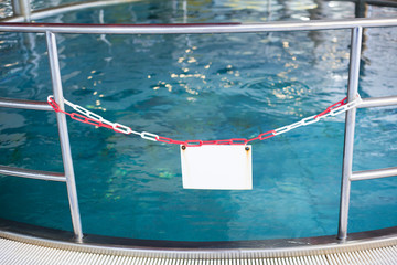 white sign in front of a swimming pool