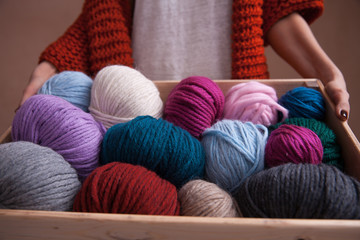 Box witn yarn balls in woman hands