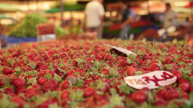 IZMIR - JULY 2015: Fresh strawberries on market at the biggest and most crowded bazaar in the city. Located in Bostanli, Karsiyaka