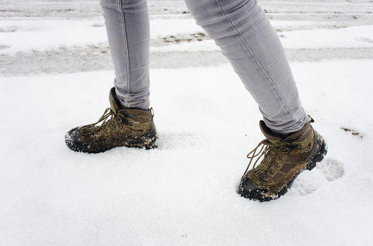 Female Legs In Hiking Boots Walking In Snow