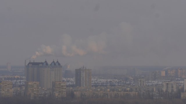 Smoke is Raising Up From a Pipe Modern Buildings View through a Smog Cityscape of Troeschina Borough in Kiev Left Bank of a Dnepr River Winter Christmas