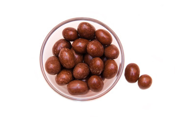 Bowl of chocolate candy on a white background seen from above