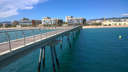 Fototapeta na wymiar Bridge Oil - Pont del Petroli, Badalona, Spain, a place for walking over the sea