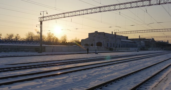 Panorama of Rails Empty Railway Station of Konotop City in Winter Wire Towers Buildings of a Station Snow on a Ground Sunset Clear Sky Ukraine