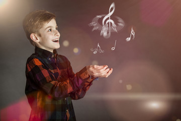 Musical Notes Over the Hands of a Happy Boy - obrazy, fototapety, plakaty