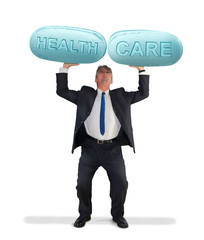 Man holding up giant pills saying HEALTH CARE