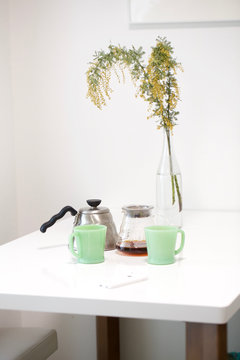 Cup of coffee and flower on table in Dinning room 