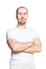 Portrait of a confident bald bearded man in white t-shirt isolated on white