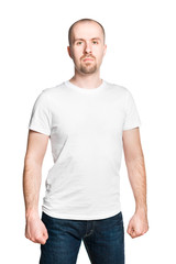 Handsome bald breaded man with clenched fists in white t-shirt and jeans isolated on white