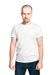 Handsome grinning bald breaded man with clenched fists in white t-shirt and jeans isolated on white
