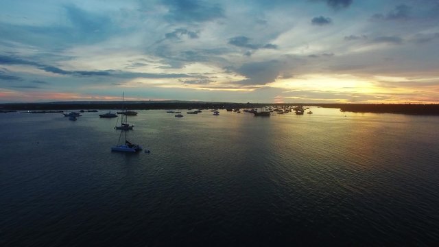 Aerial view of Bali at sunset. Popular summer beach in Indonesia with indian ocean and view on the bay with yachts
