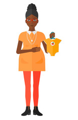 Pregnant woman with clothes for baby.