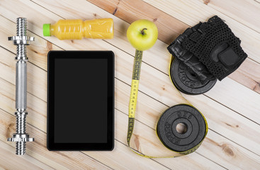 Sport Equipment. Barbell, Weight, Gloves, Towel, Orange Juice, Apple Tape Measure And Tablet To Workout Plan On Wooden Boards. Sport Fitness Background