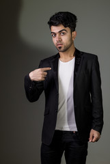 Studio shot of Iraq brunette boy wearing black suit