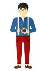 Smiling photographer holding camera.