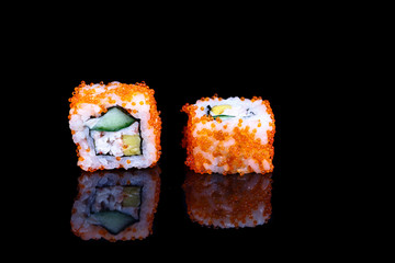 Traditional California roll on a black mirror.