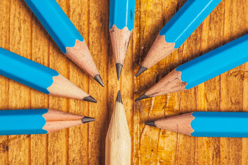 Standing out from the crowd with wood pencils on desk