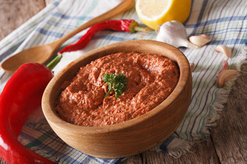 Red Muhammara and ingredients close-up. Horizontal
