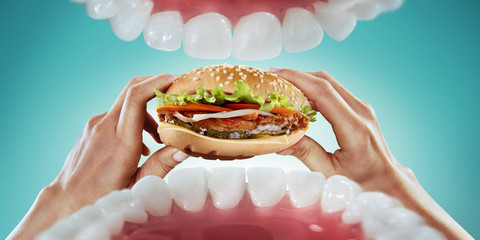 Fast food and diet. Hands hold the hamburger