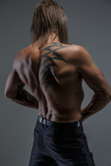 Fototapeta na wymiar Shirtless man's back with tattoo.