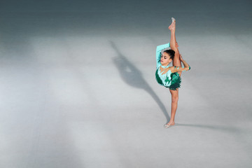 gymnast performs  balance and splits