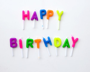 Colorful candles in letters saying Happy Birthday