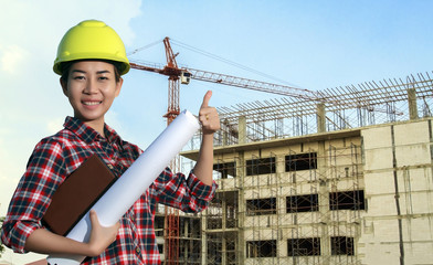 portrait women asia engineer working and holding blueprints at c
