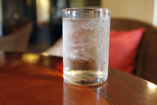 glass of water on wood table for drink at summer