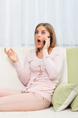 Shocked woman on the phone