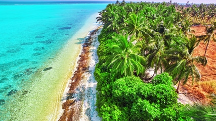 Shoreline of a tropical island in the Maldives and view of the I