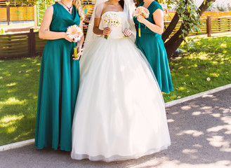 Fototapeta premium Bride, row of bridesmaids with bouquets at big wedding ceremony. 