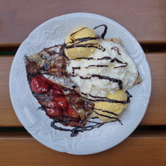 Pancake with vanilla ice cream, cherries and whipped cream