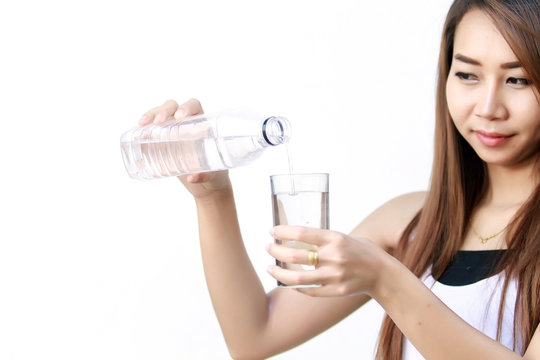 Portrait of young beautiful woman asia drinking water at summer and holding bottle