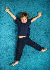 Boy lying on the carpet
