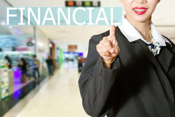 Businesswomen hand touching FINANCIAL sign on virtual screen on