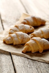 Fresh homemade croissants on a grey wooden table
