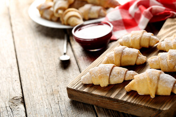 Fresh homemade croissants on a grey wooden table