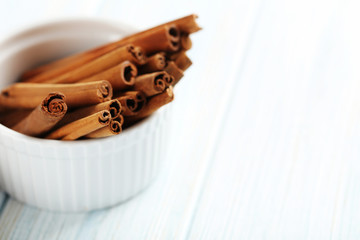 Cinnamon on a blue wooden background