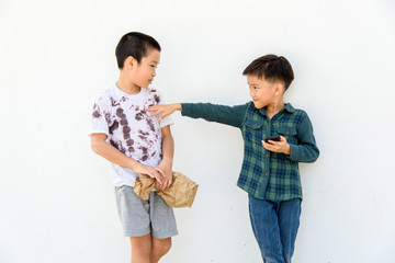 Young boy play smartphone compare with poor boy