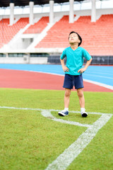 Fototapeta premium Boy stand on the football field.