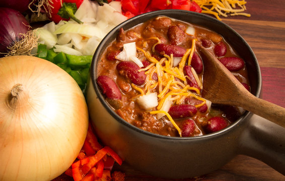 Spicy Bowl Of Chili. Hot bowl of fresh chili with cheese, onions, and peppers.