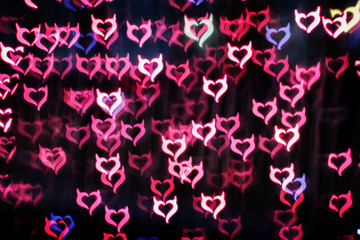 Naklejka na ściany i meble Blurring lights bokeh background of Devil hearts