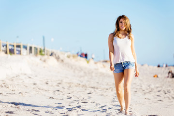 Young woman walking along the beach