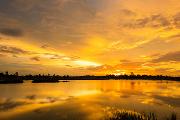 Naklejka na ściany i meble Sunset with Golden light over the lake