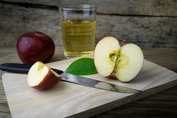 Apple juice and apples on a wooden table