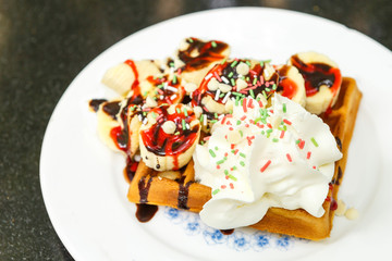 Waffle with banana slices and cream