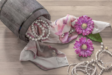 Still life details, scarf and pearls in retro vintage wooden box