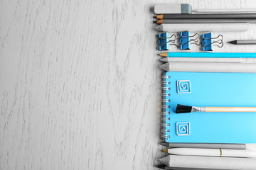 Office supplies on light wooden background