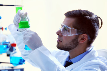 Man in laboratory checking test tubes